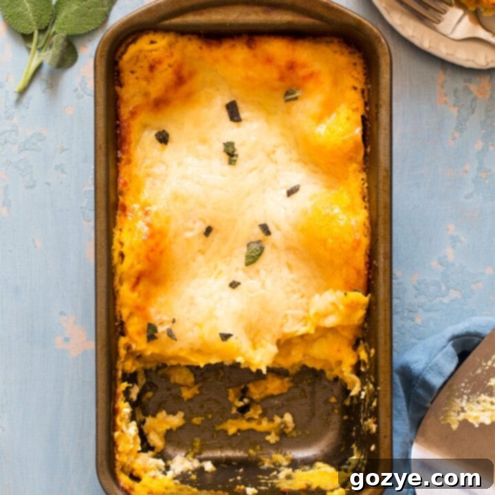 Butternut squash lasagna in a loaf pan with a slice served