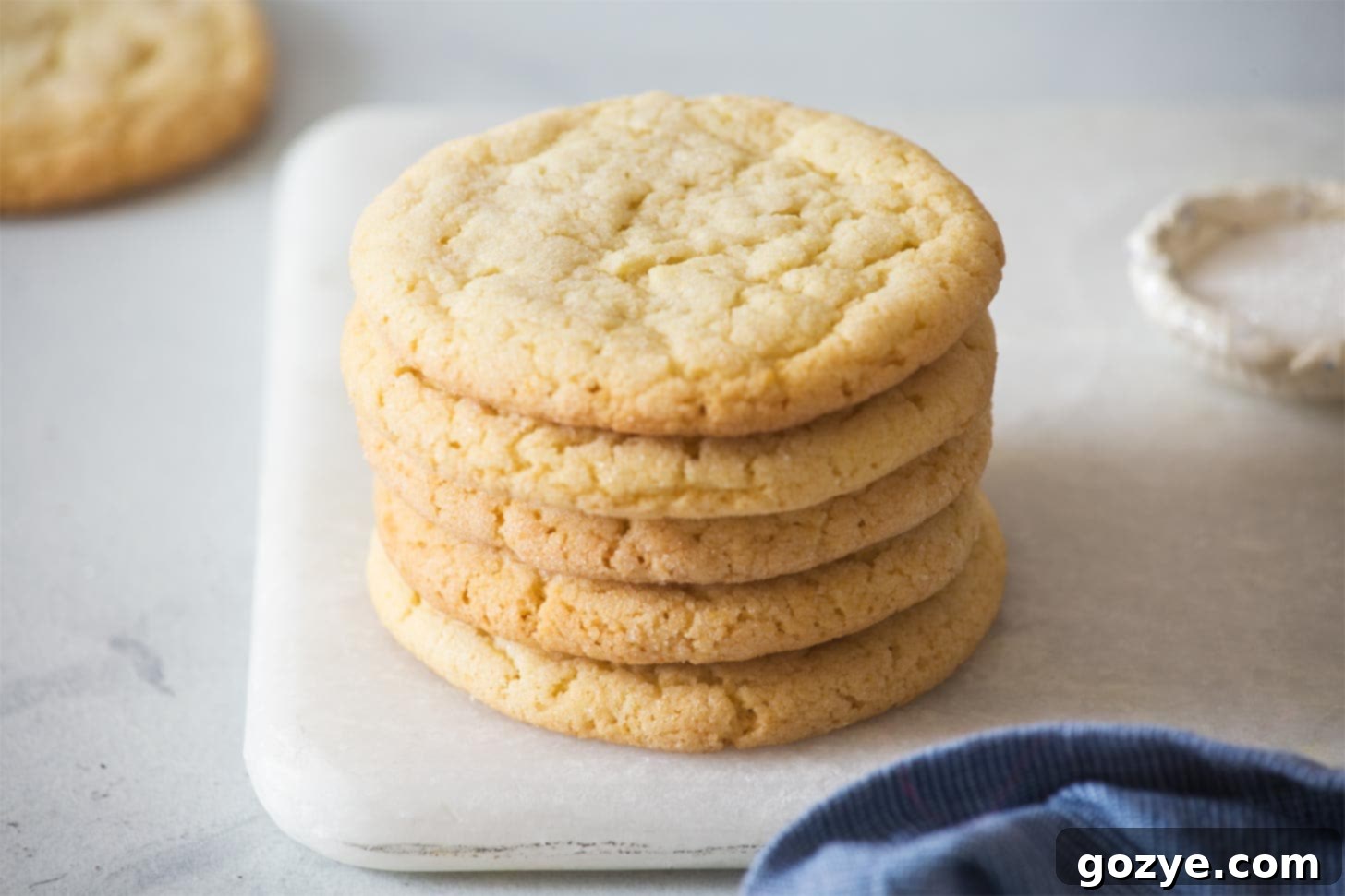 Stack of easy sugar cookie recipe on marble board