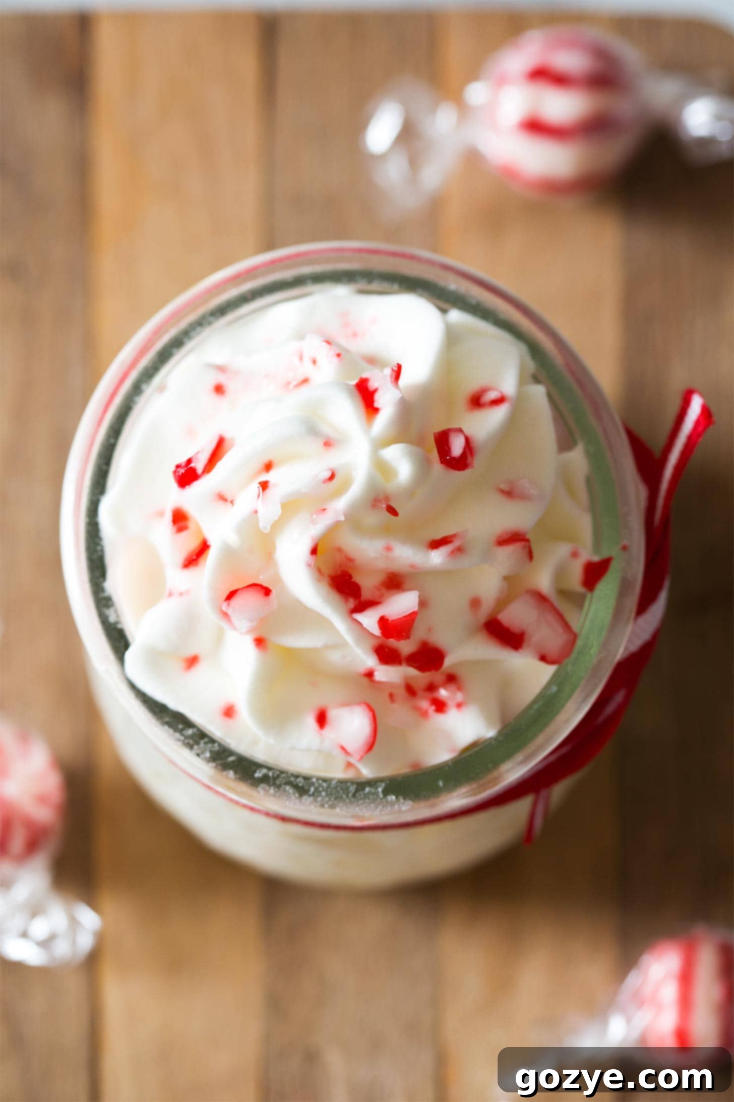 Overhead shot of peppermint cream in jar with candy canes
