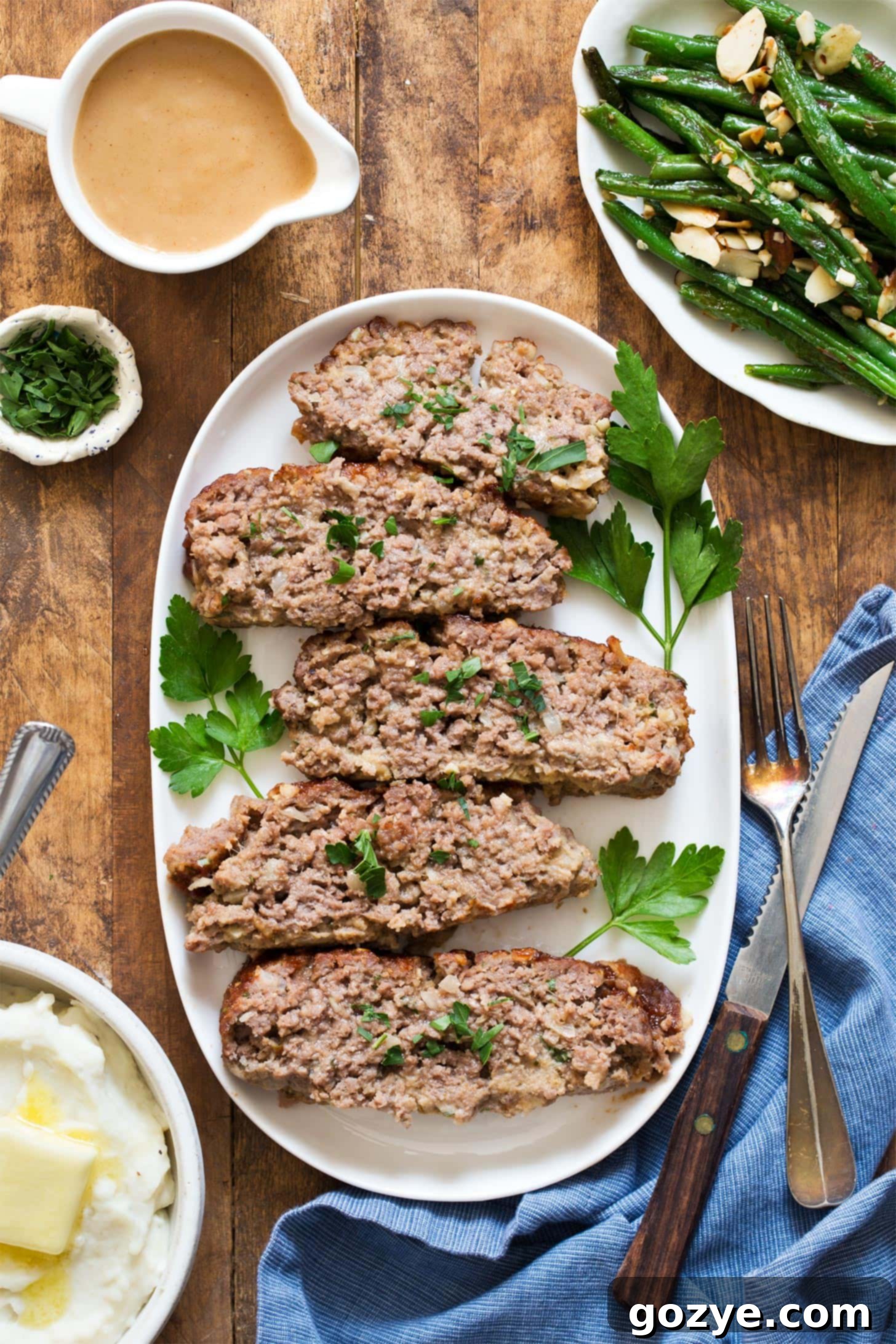 Slices of small meatloaf served on a plate - a perfect portion for two.
