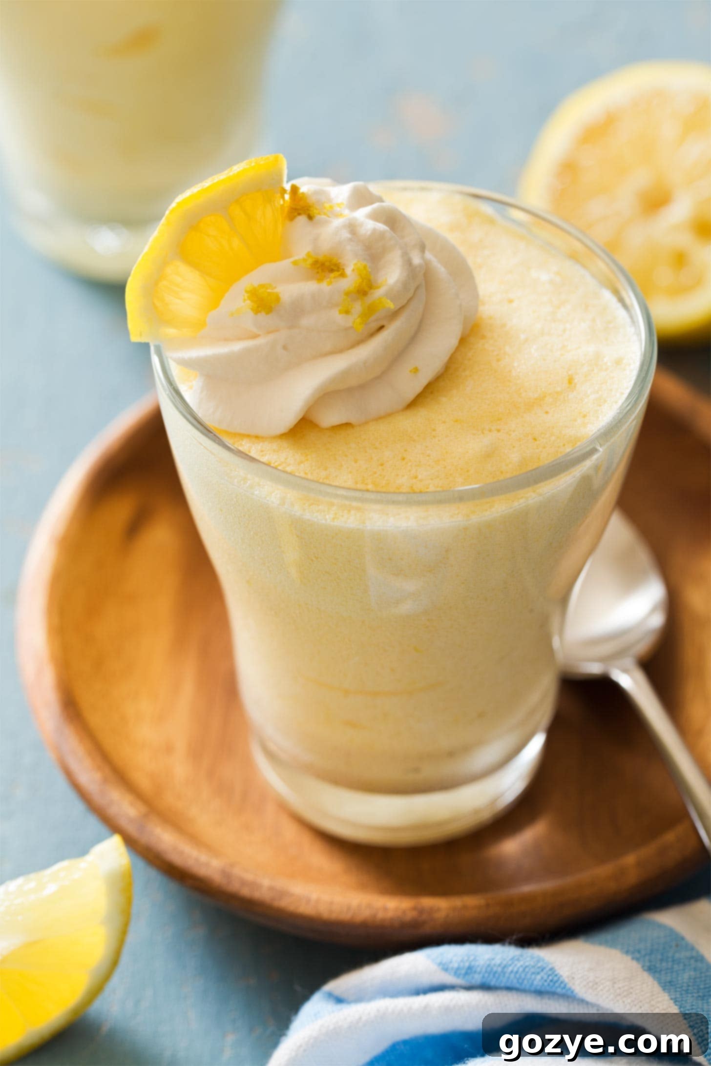 Lemon mousse in a cup with whipped cream